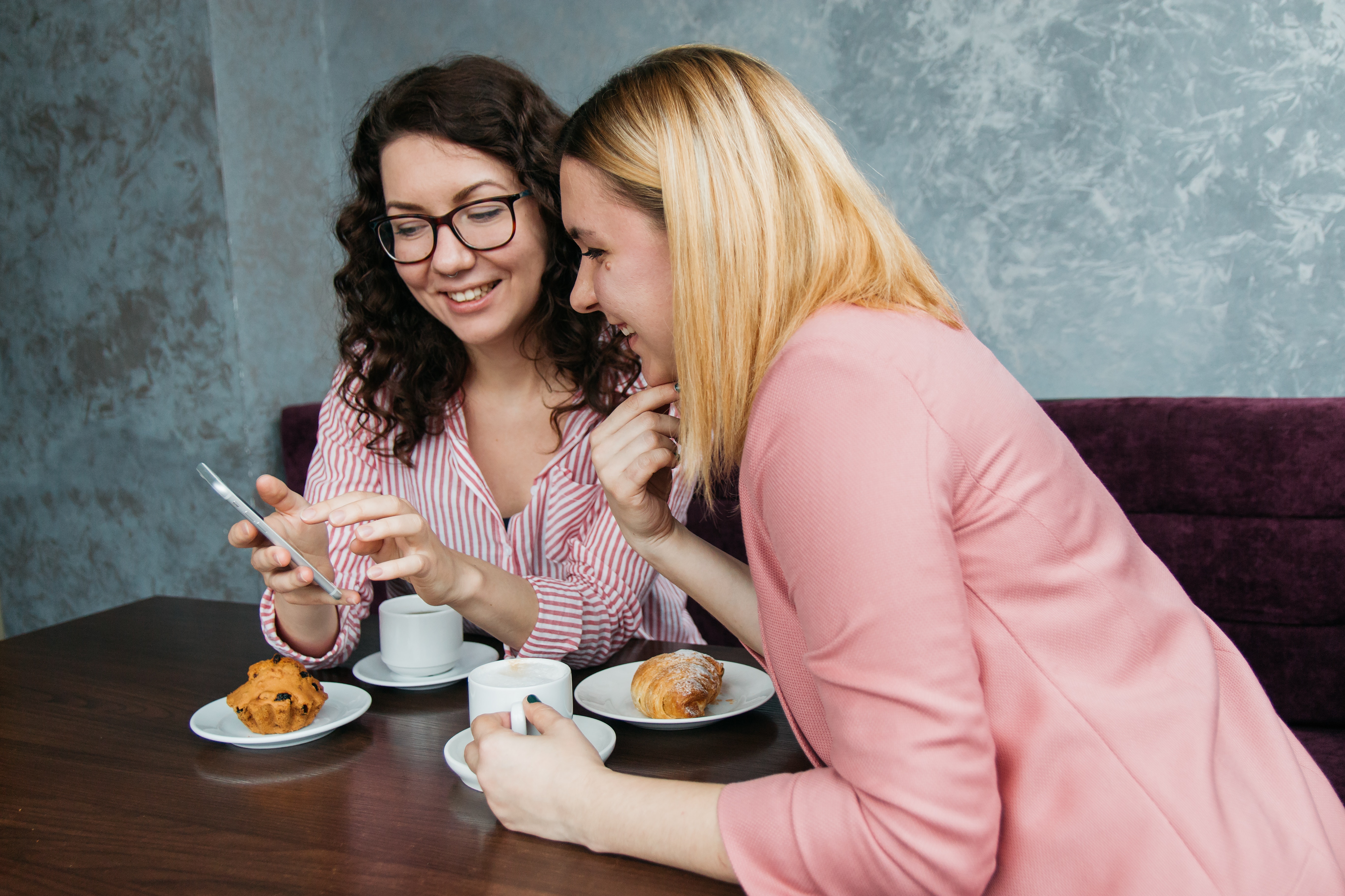 two women looking at a smartphone together